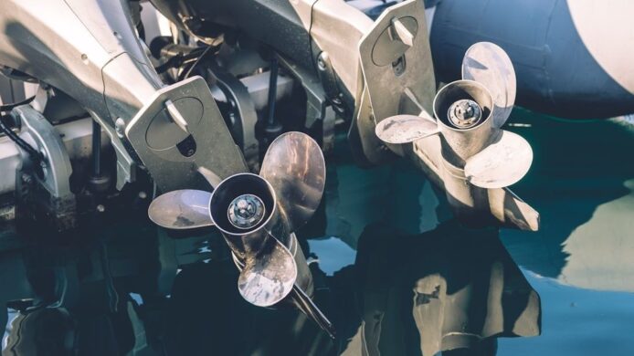 To båtmotorer med propeller under vann, med synlig slitasje